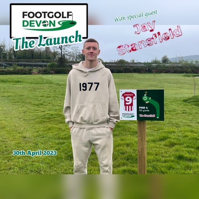 One of the Footgolf Devon team standing at the sign for hole 9 for a picture