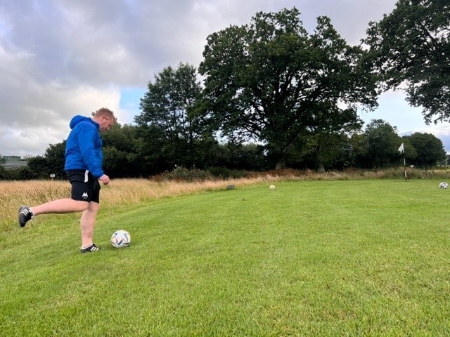 Footgolf Devon League player looking down at the football before kicking it